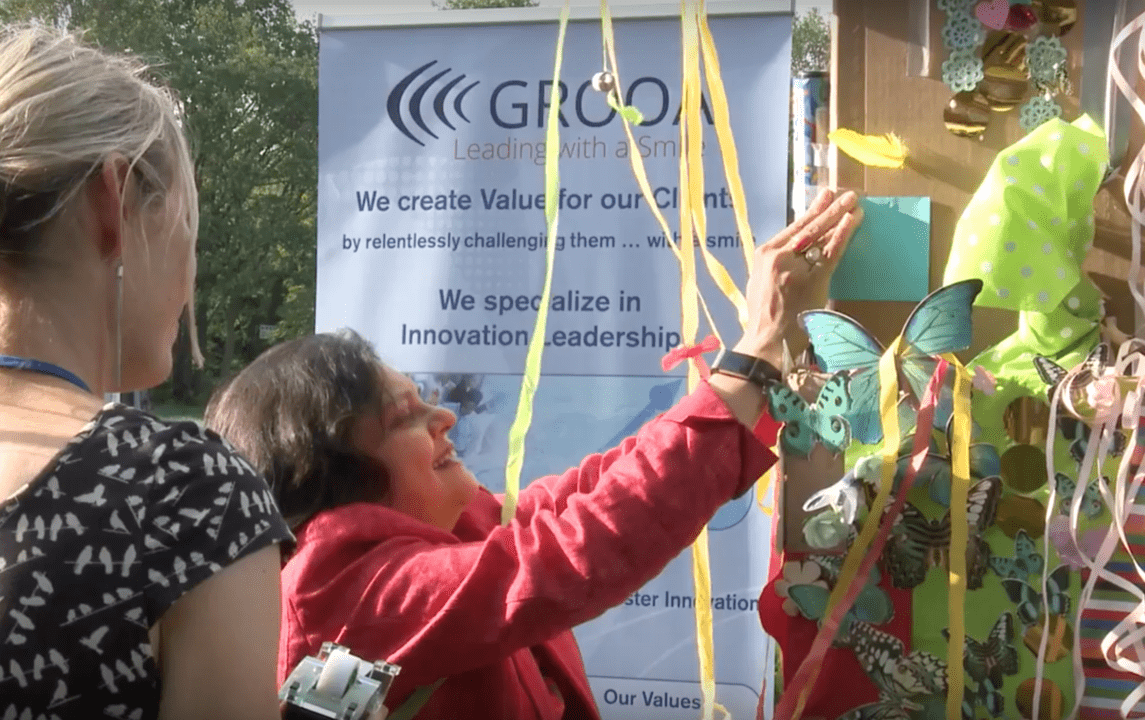 Women Building a creative wall with paper butterflies